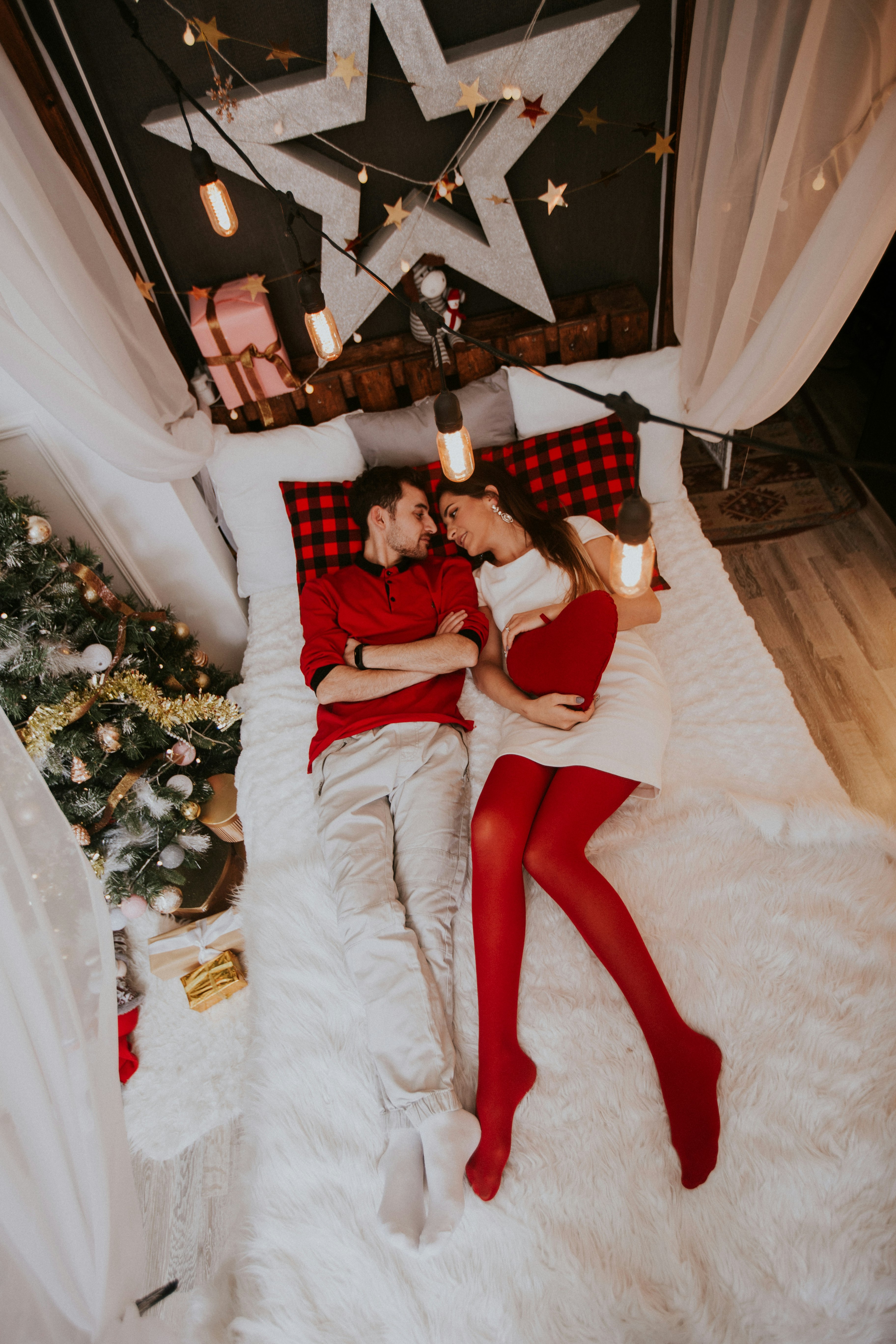 man and woman laying on bed